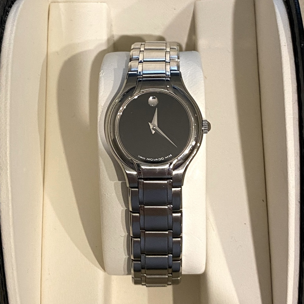 Movado ladies watch, classic stainless steel with black face.